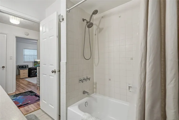 Enjoy the flexibility of a full tub and shower combination, finished with classic white tile and a handheld showerhead.