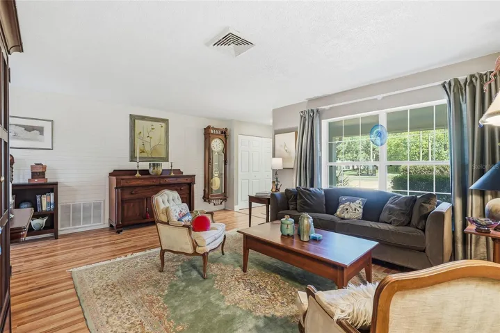 A generous front window frames leafy views and fills this welcoming gathering space with natural light.