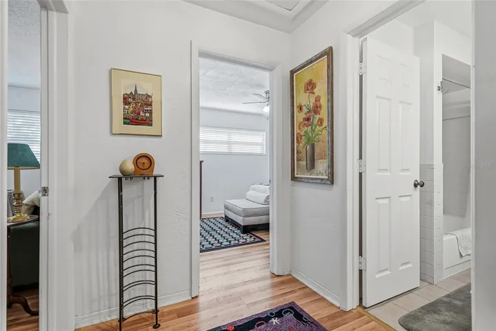 Two additional bedrooms and a shared bath are grouped together off their own hallway, creating a comfortable setup for guests or a bedroom and home office.