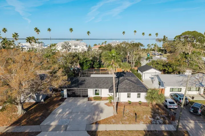 Nestled amongst the palms. Large driveway with two car garage!
