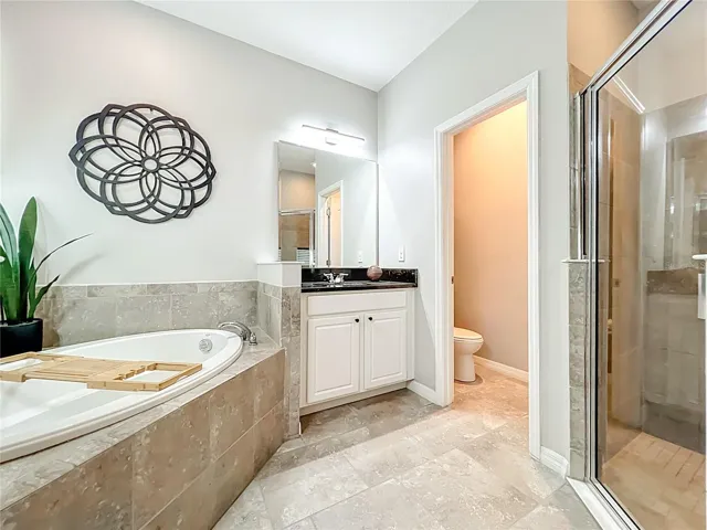 Master bathroom with soaking tub and separate vanities and walk in shower