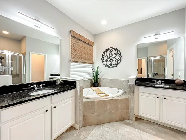 Master bathroom with separate vanities and garden tub.