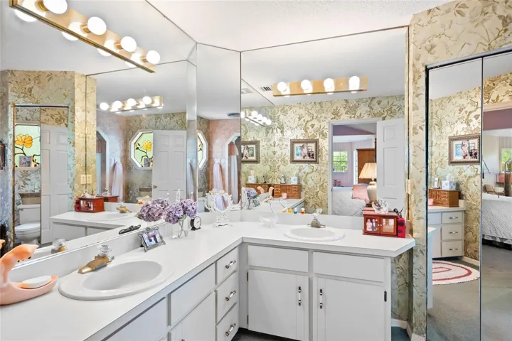 Dual sinks and linen closet in Owner's Bath