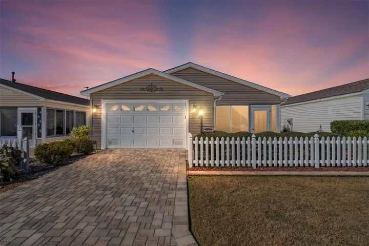 Charming Cabot Cove exterior with expanded paver driveway and enclosed front lanai.