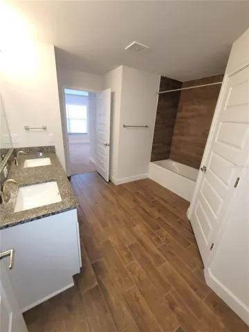 Jack-in-Jill Bath with dual sinks and vanity drawers