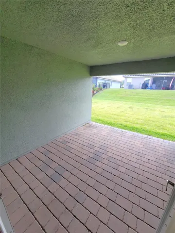Covered Lanai with pavers out of French doors from Great Room