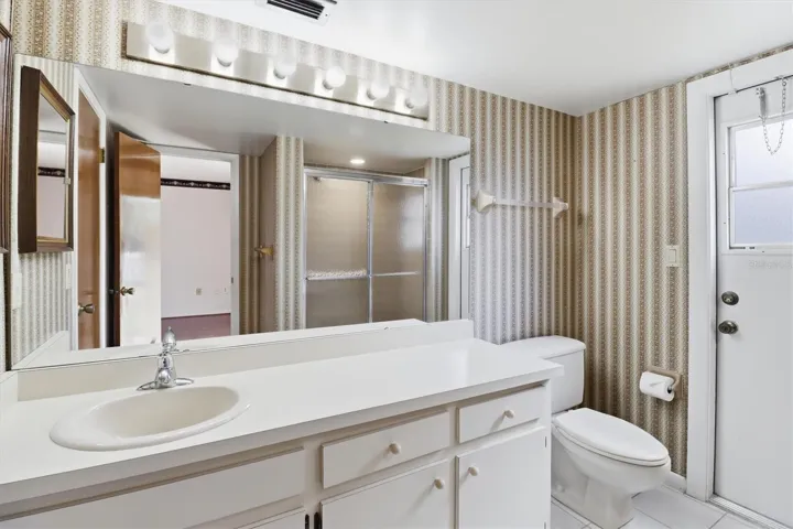 Primary bathroom with large vanity and walk-in closet