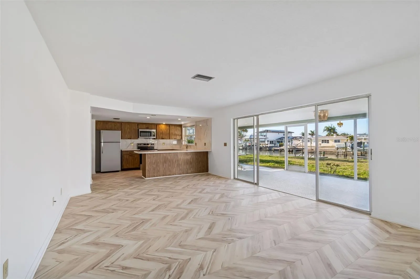 Notice the new chevron design LVP flooring in the family room.