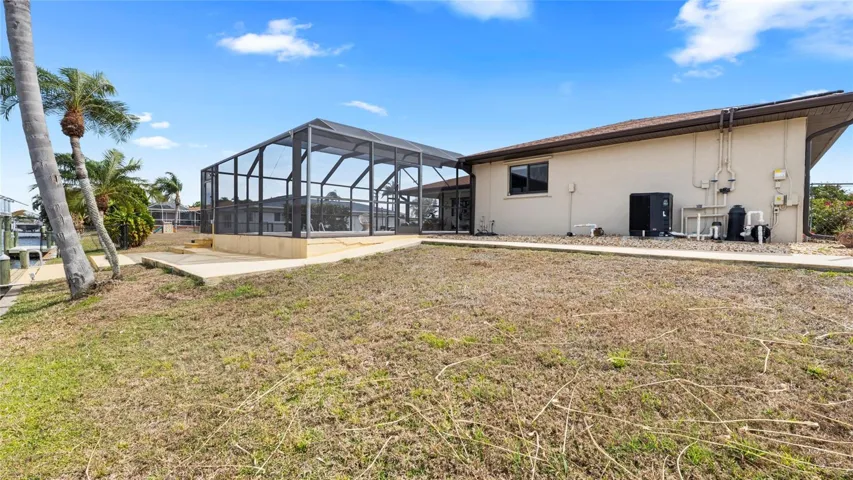 Rear view of the home and screened lanai