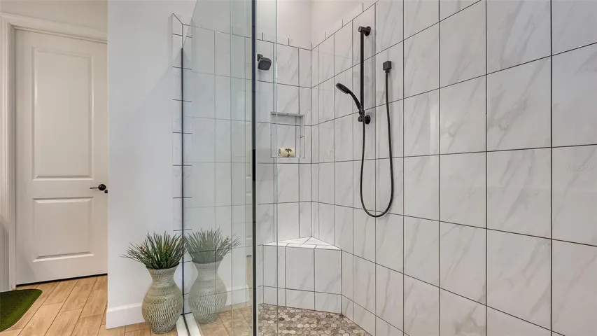 Frameless glass walk-in shower with dual shower heads