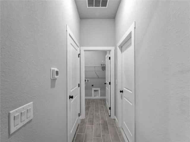 Hallway to interior laundry and garage