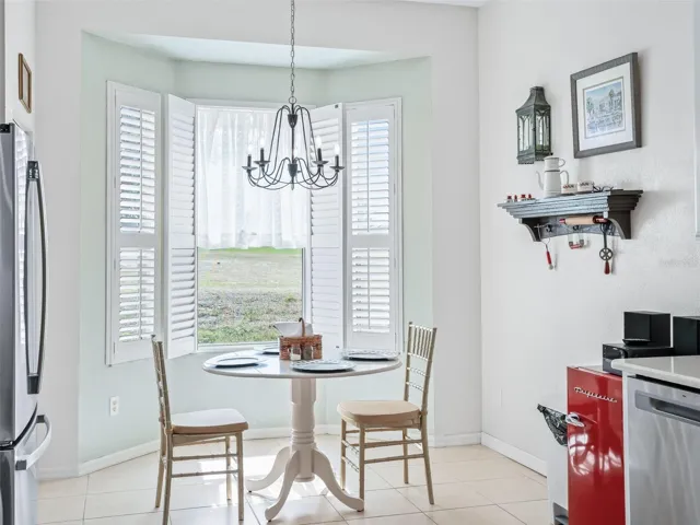 Eat in Area w/Plantation Shutters & Designer Chandelier