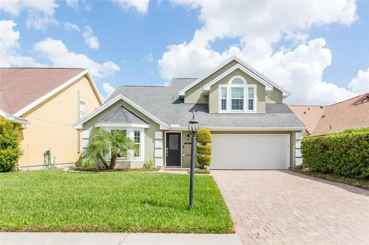 The paver driveway and lush lawn set the tone for the impeccable interior