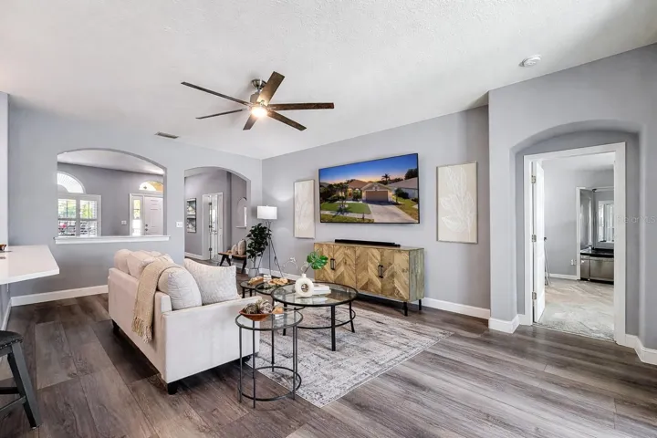 Spacious great room, arched features and entrance to master bedroom on your right.