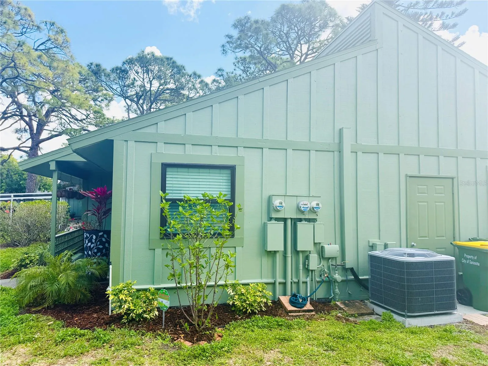 west-facing side of house with A/C and for to storage closet