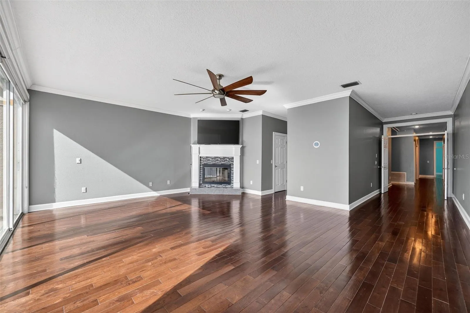 The spacious Primary bedroom is a sanctuay with a wood burning fireplace, hardwood flooring, double walk in closets, and private balcony.
