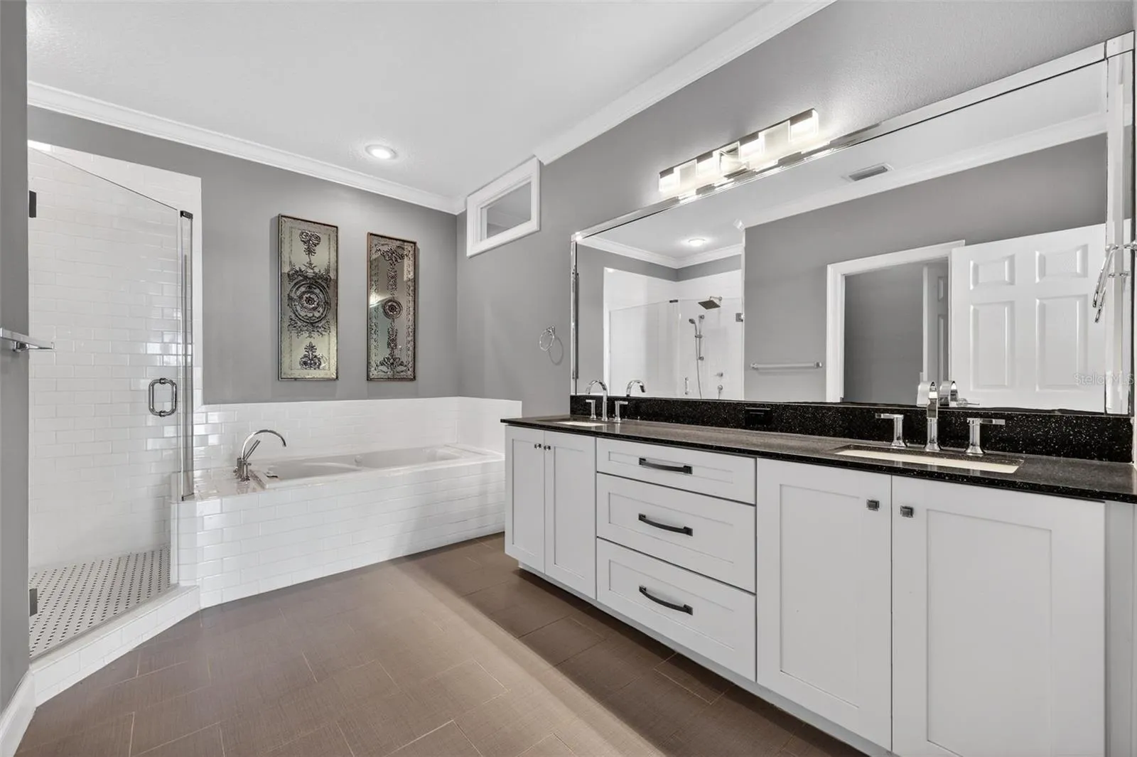 Primary bathroom is large with walk=in shower, soaking tub and double vanity with pleanty of storage