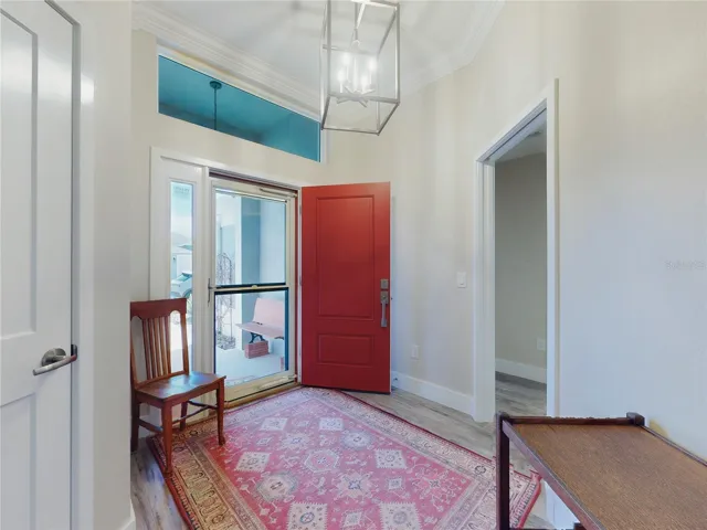 FOYER WITH SIDELITE, TRANSOM, AND ADDED GLASS STORM DOOR WITH UPPER SCREEN. NICE TO HAVE FOR A FRESH BREEZE THIS TIME OF YEAR.