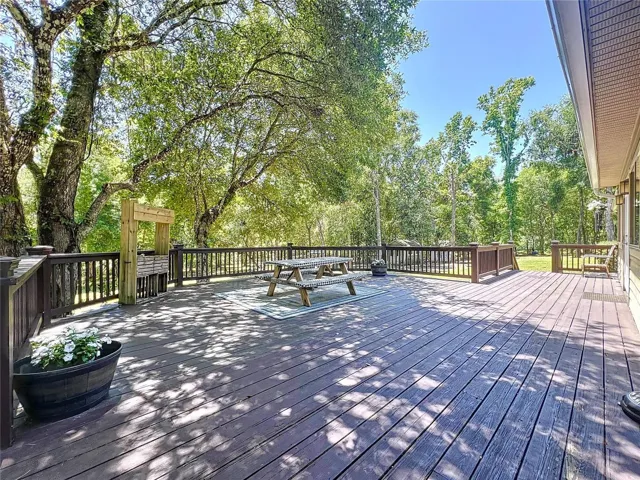 WIDE DECK RUNS ALONG ALMOST ENTIRE LENGHT OF THE HOME