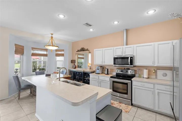 open plan kitchen with pool and pond views