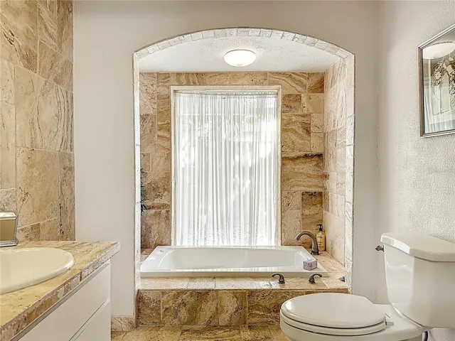 Relax in this sunken jetted tub .Timeless elegance with a soothing, spa-like vibe.