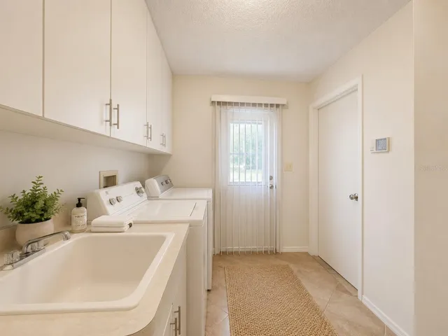 Convenient laundry room located just off the two car garage for easy everyday living. A well-organized space with generous closet storage and convenient side-door access leads to a side yard for additional yard space .