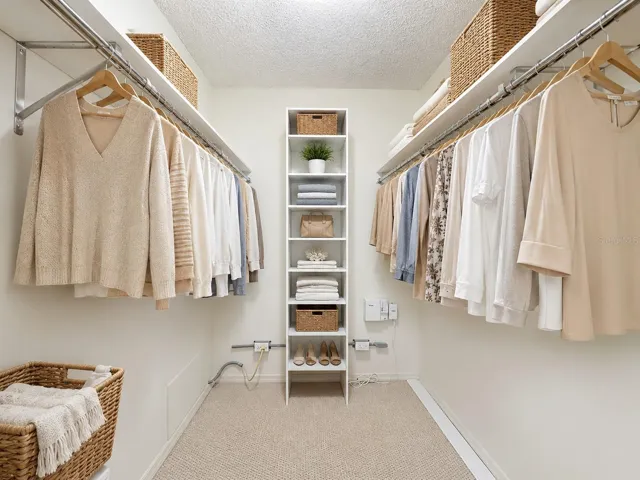 Primary bedroom with a spacious walk in closet.