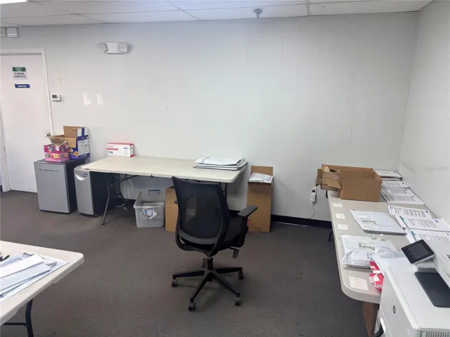 View of office space toward entrance of warehouse.