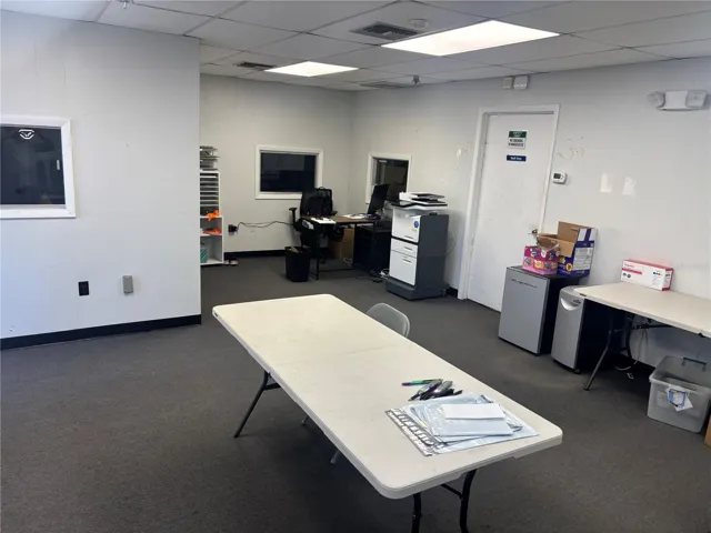View of corner office area, bonus room and entrance toward warehouse.