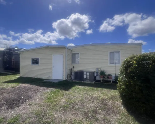 back of home with second storage shed