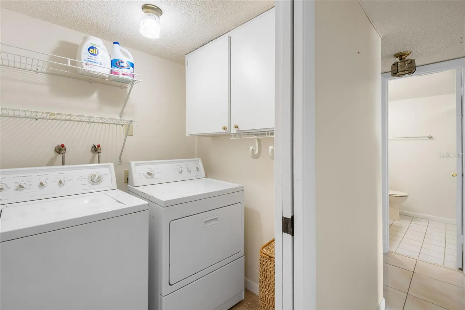 Laundry room with cabinet storage and shelving