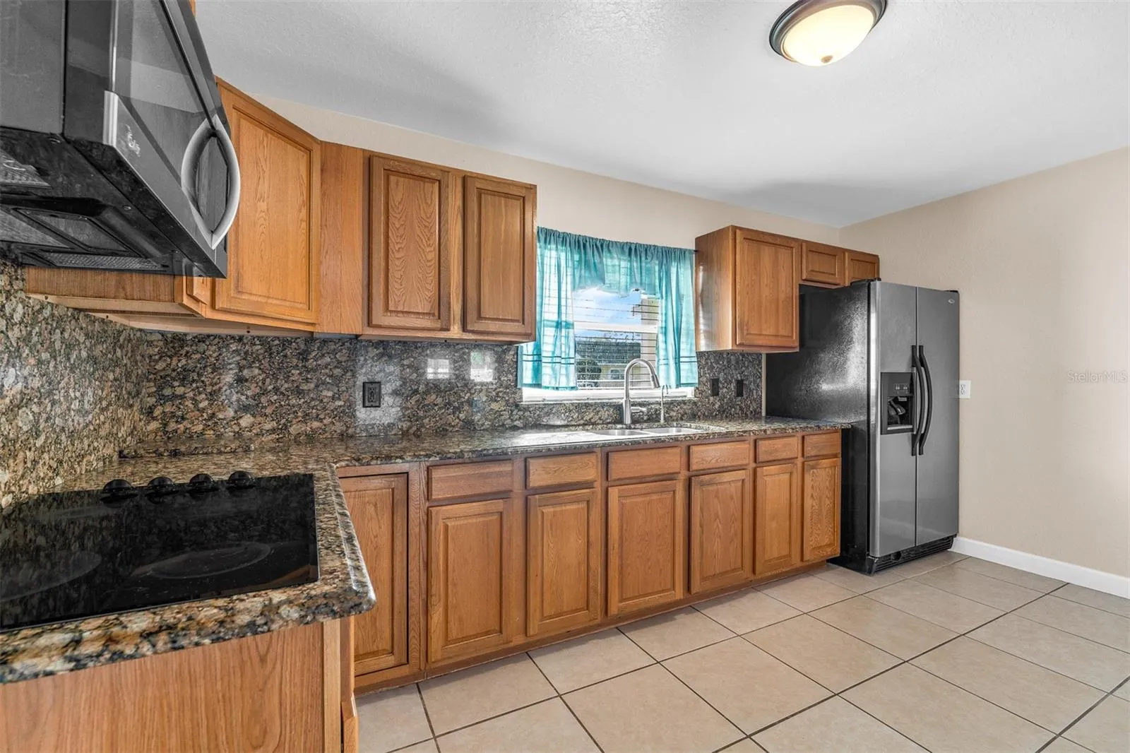 Kitchen counter with bar seating overlooking the living area. Open layout provides easy flow between spaces.