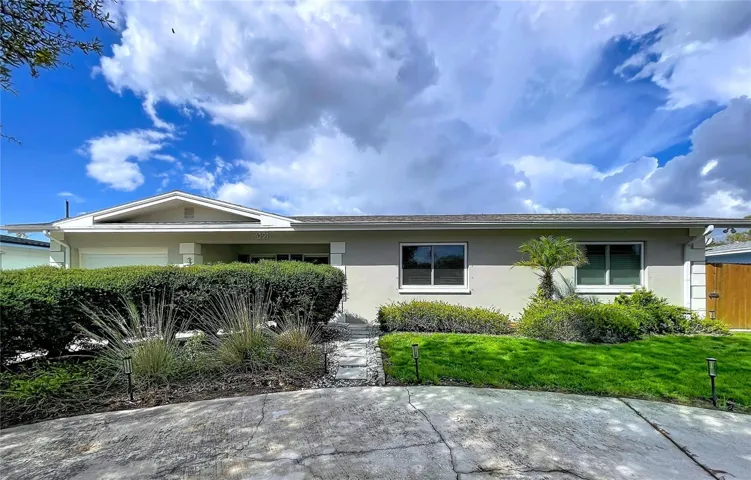 The front view features a circular driveway that adds charm and practicality, creating an inviting entrance and allowing for smooth vehicle flow and convenient guest parking.