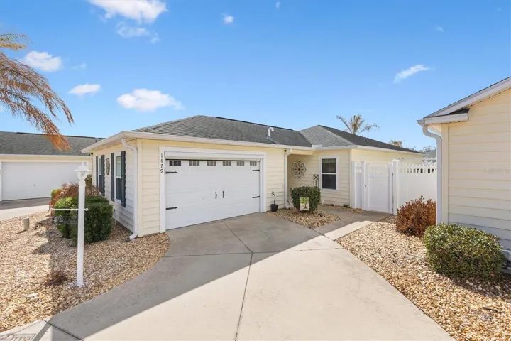 Beautifully maintained Biscayne Courtyard Villa in the Village of Santiago in The Villages, Florida, featuring low maintenance landscaping, a private courtyard entry, and charming curb appeal in this move in ready villa home.