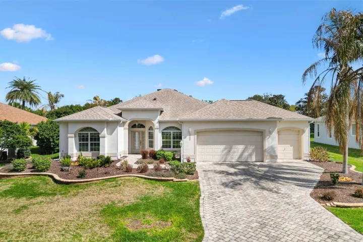 Open concept living and dining space with tile flooring, high ceilings, and breakfast bar overlooking the kitchen for comfortable everyday living and entertaining.