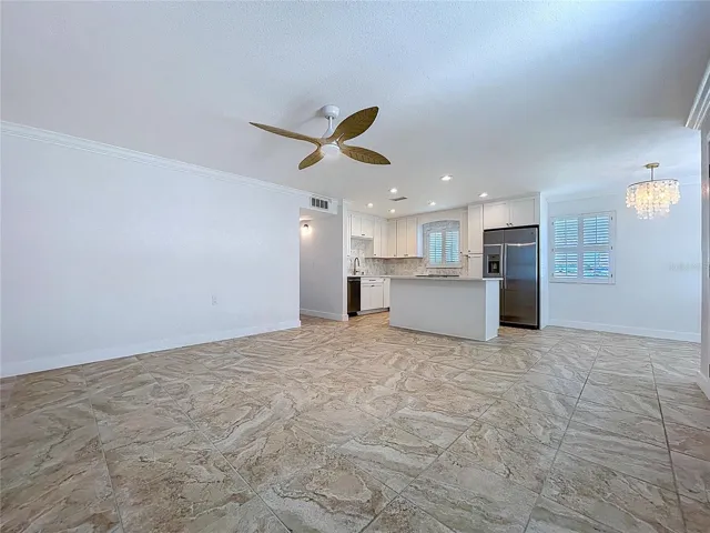 Open living space combines the living room, kitchen and dining room.