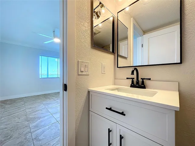 Fully renovated Primary bathroom with walk-in shower and glass shower door.