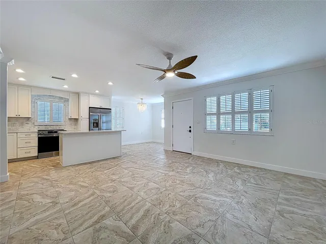 Open living space combines the living room, kitchen and dining room.