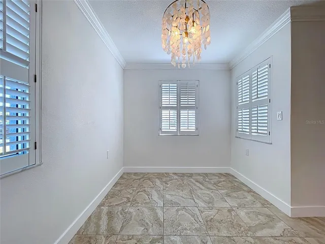 The dining room offers three bright windows thanks to the position of this corner unit condo.