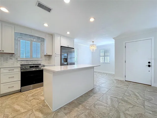 Fully updated kitchen offers all new cabinets and SS appliances.