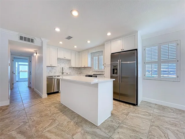 Fully updated kitchen offers all new cabinets and SS appliances.