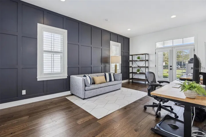 Downstairs Bedroom with French Doors to the Front Porch and Pool