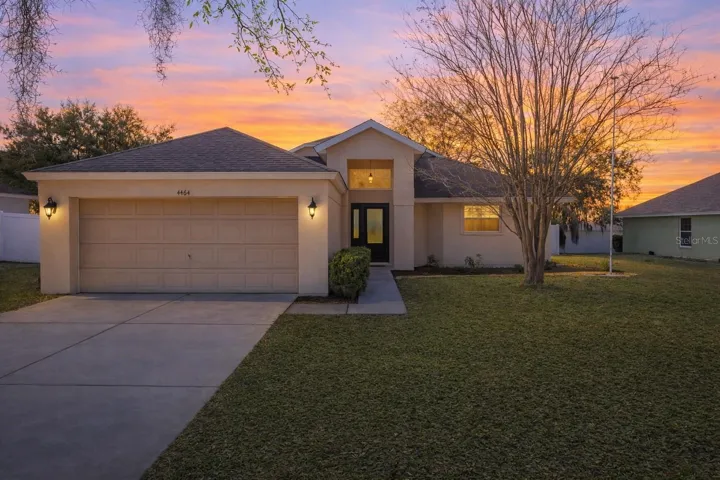 Charming front exterior featuring a two-car garage