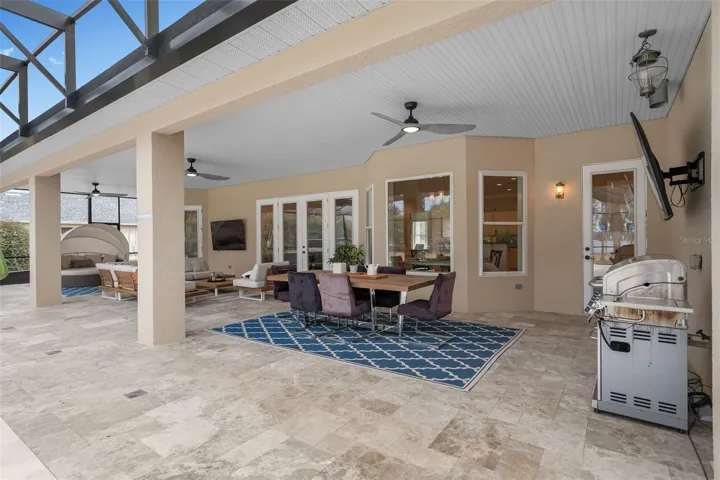Oversized covered lanai designed for year-round outdoor living, dining and entertaining with peaceful water front views.