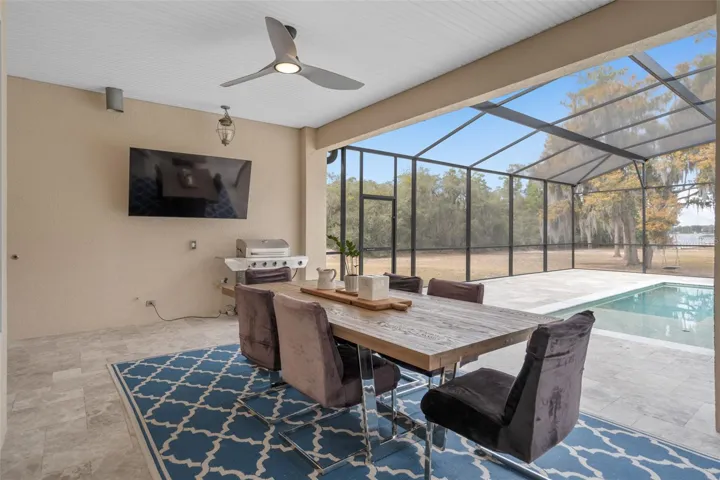 Oversized covered lanai designed for year-round outdoor living, dining and entertaining with peaceful water front views.