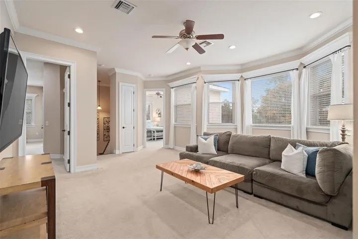 Second-floor loft featuring expansive windows that flood the space with natural light and frame stunning lake views.