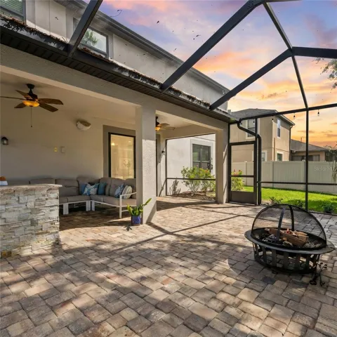 Oversized screened in lanai with waterfall feature and outdoor kitchen.