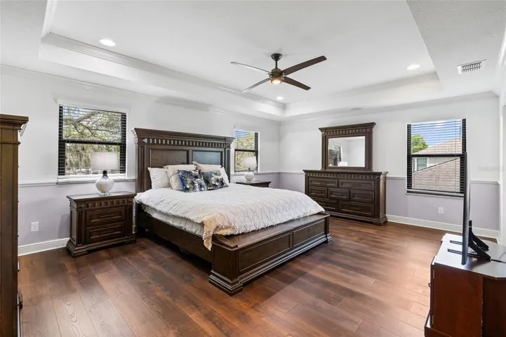 Primary Suite with engineered hardwood and Tray Ceiling.