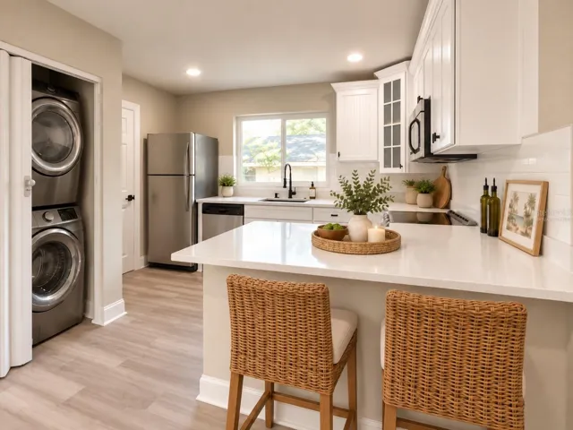 Virtually Staged Kitchen. Updated kitchen with quartz countertops, stainless appliances and breakfast seating.