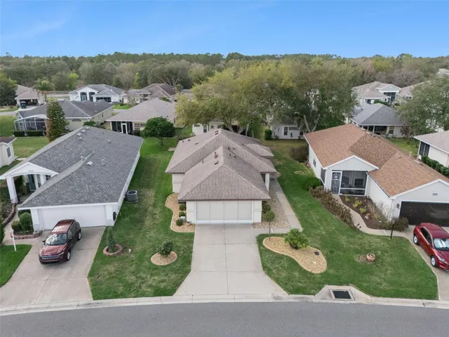 AERIAL SHOT OF FRONT OF HOME SHOWING TIDY, EASY-TO-MAINTAIN LANDSCAPING
